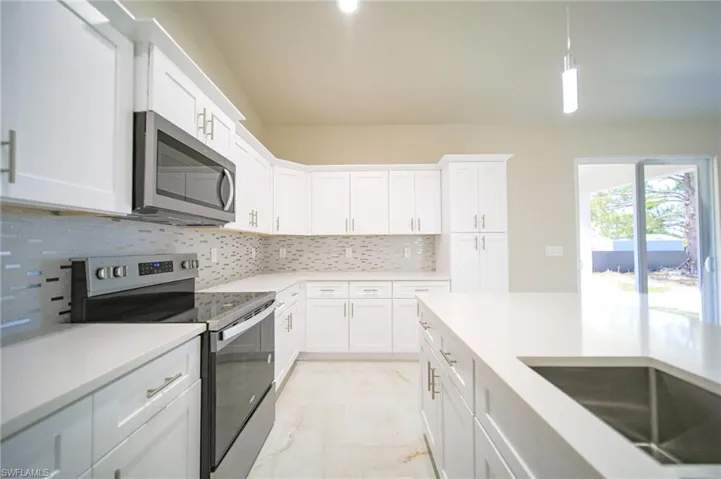 The Island Kitchen Comes With Quartz Countertops, Real Wood Flat Panel Cabinets & Drawers, A Floor To Ceiling Pantry, Brand New Stainless Steel Appliances, And A Tile Backsplash!