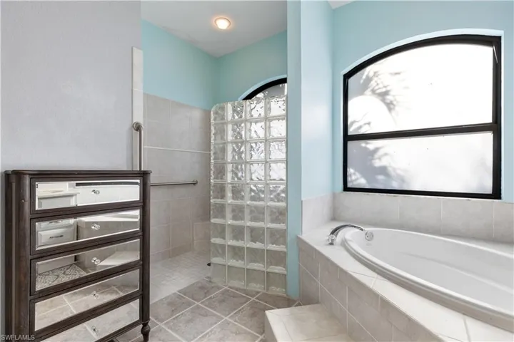 Large Garden Tub and a large step in shower decorated with classic GLASS BLOCK!