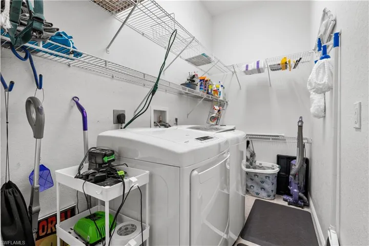 Large Inside Laundry Room accommodates full size washer/dryer, along with lots of storage space and shelves!