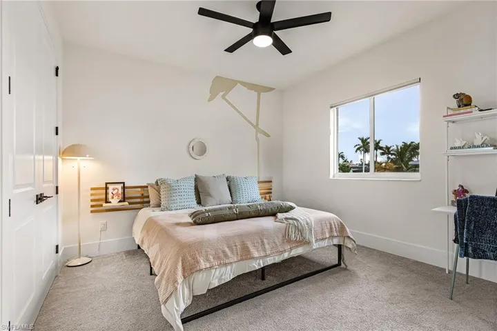 Third Bedroom featuring carpeting and a custom flamingo wall mural