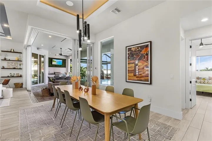 Formal Dining Area with pool views and eclectic light fixture