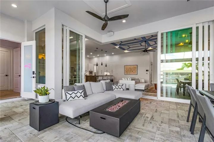 Deep-Covered and Screened-In Lanai with two ceiling fans and an electric fire pit