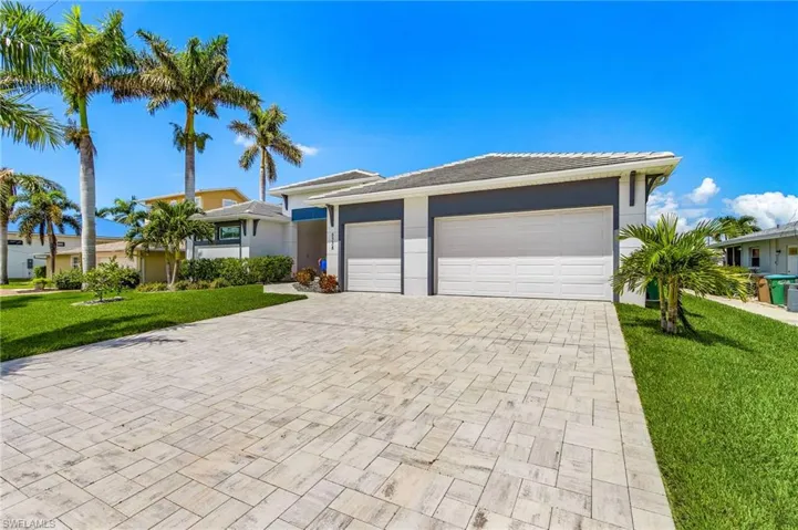 Paver Stone Driveway leading to a 3-Car Garage