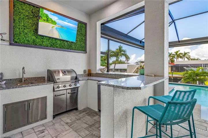 Built-In Napolean Grill, Bar Top and Television perfect for watching your favorite television program