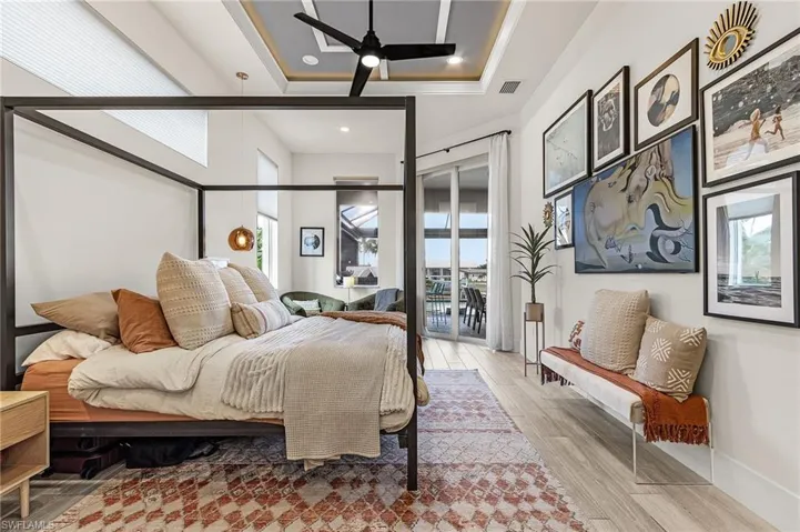 Main, Primary Suite with high, tray ceilings and private access to pool area