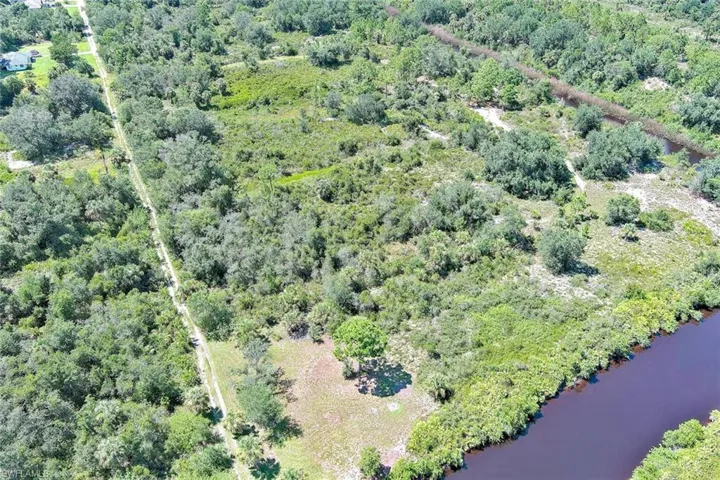 Aerial overview of property's location with a large body of water