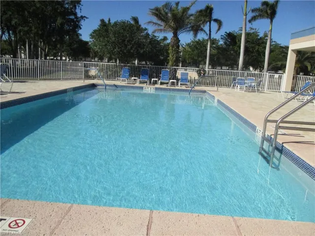 Community pool with a patio