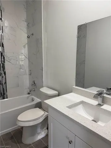 Bathroom featuring vanity and shower / tub combination