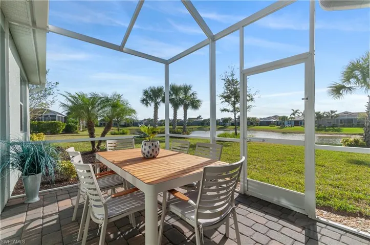 Sunroom / solarium featuring a water view