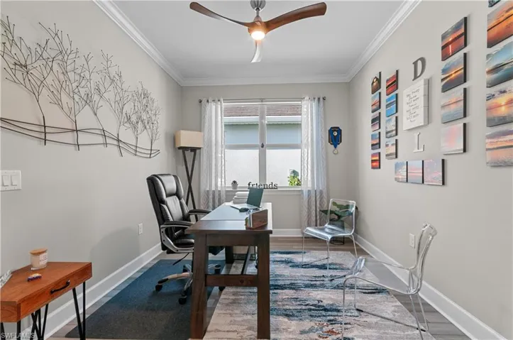 Office space featuring hardwood / wood-style floors, ceiling fan, and ornamental molding