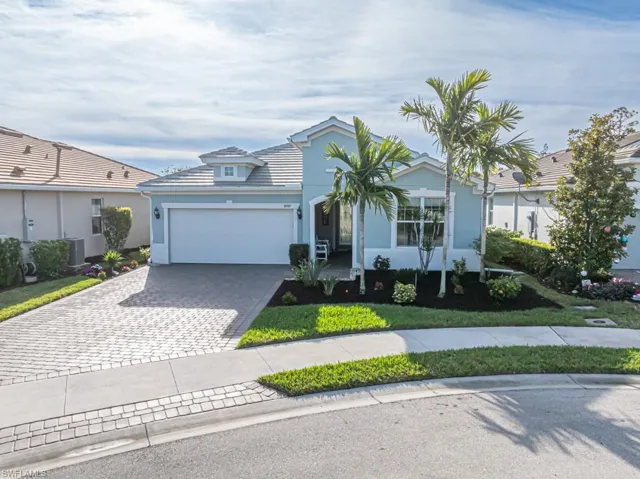 Single story home featuring a garage and cooling unit