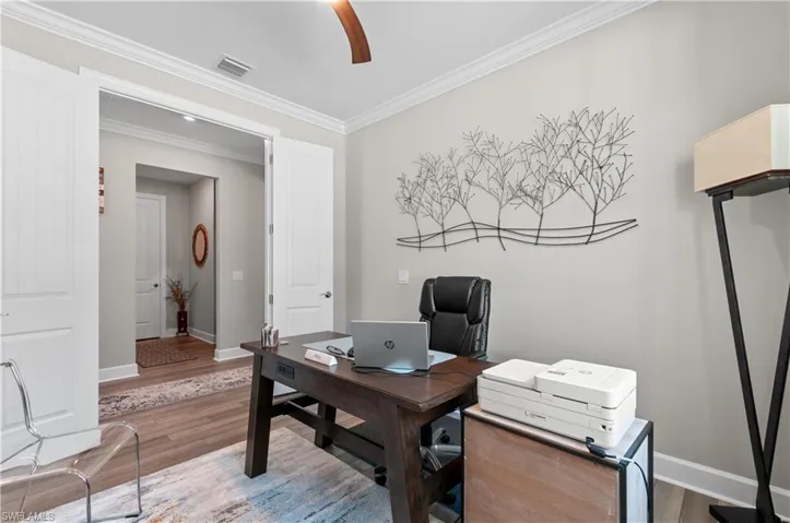 Office featuring wood-type flooring and ornamental molding