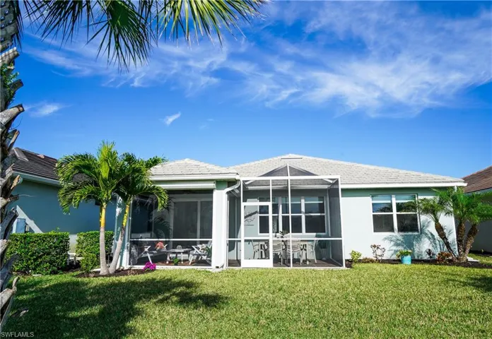 Rear view of property with a yard