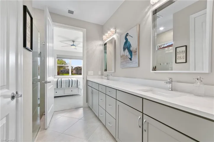 Bathroom featuring tile patterned floors, ceiling fan, and vanity