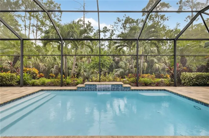 Outdoor pool featuring a sunroom and a lanai