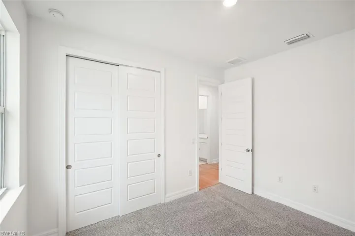 Unfurnished bedroom with carpet flooring and a closet