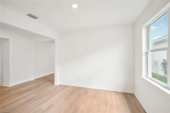 Spare room with plenty of natural light and light hardwood / wood-style flooring