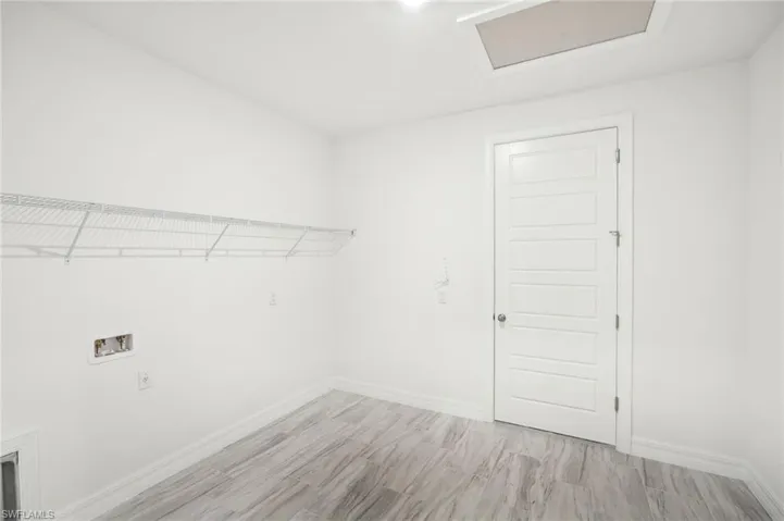 Washroom featuring light hardwood / wood-style flooring and hookup for a washing machine