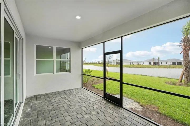 Unfurnished sunroom with a water view