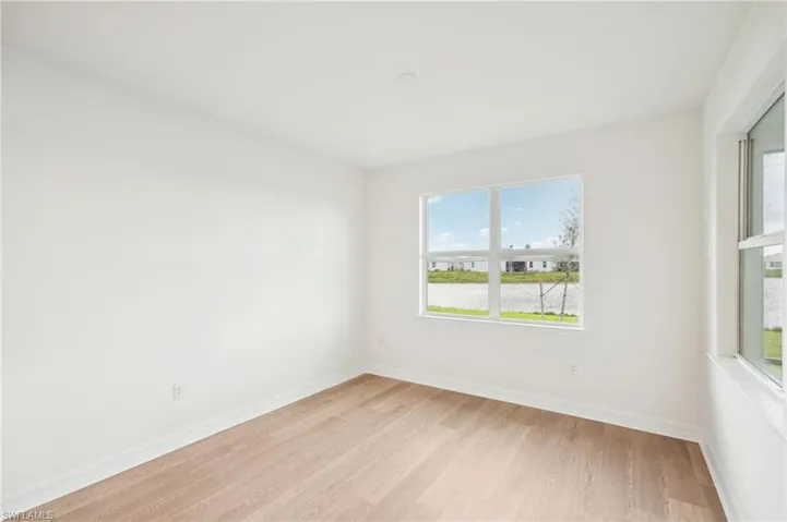 Empty room with light hardwood / wood-style flooring
