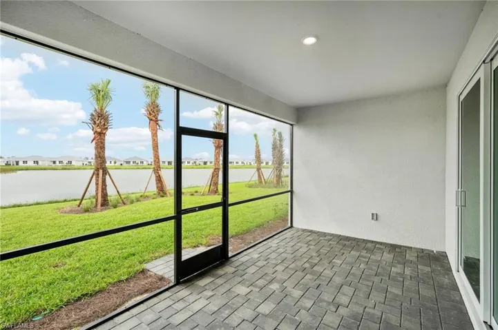 Unfurnished sunroom with a water view