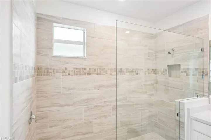 Bathroom with vanity and a tile shower