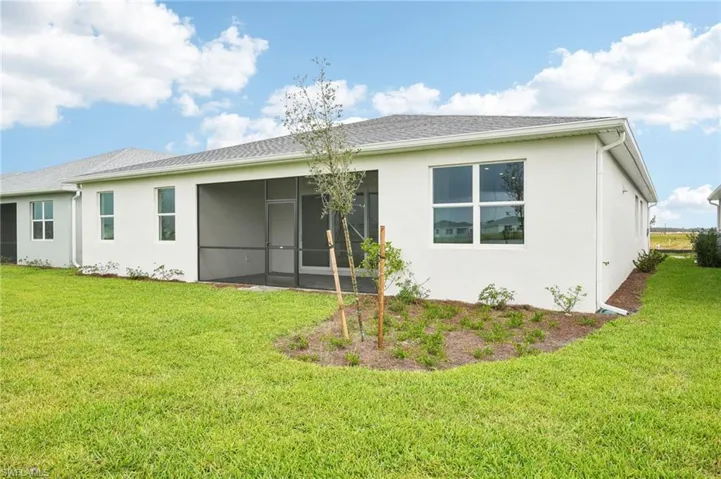 Rear view of property with a lawn