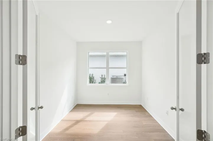 Unfurnished room with light wood-type flooring
