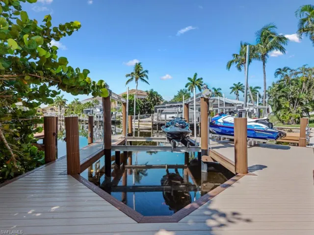 Dock featuring boat lift and a water view