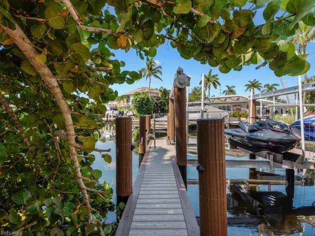 Dock featuring boat lift and a water view