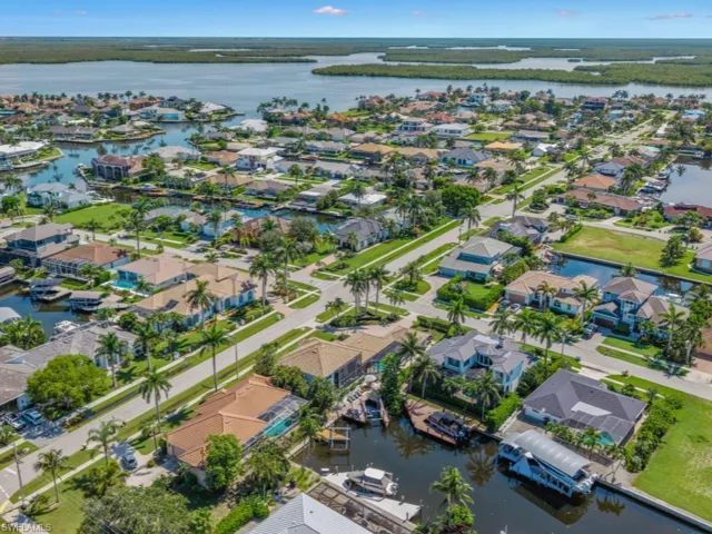 Aerial overview of property's location with a nearby body of water and nearby suburban area