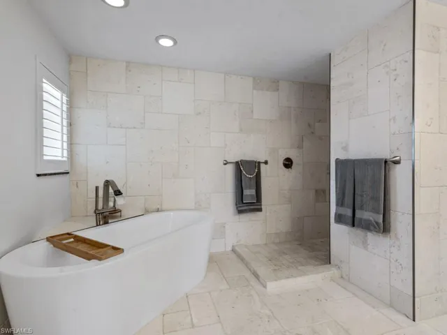 Full bathroom with a soaking tub, a walk in shower, and recessed lighting