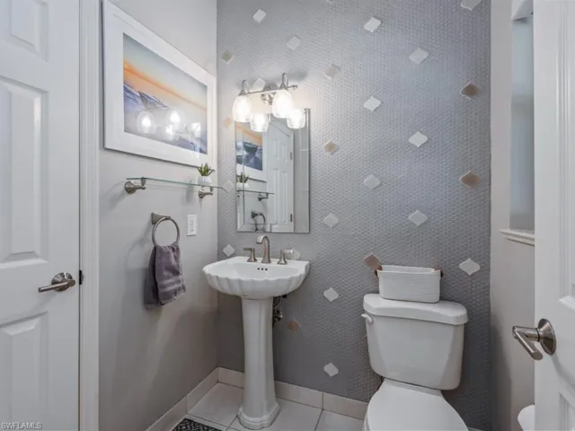 Bathroom featuring toilet and tile patterned flooring
