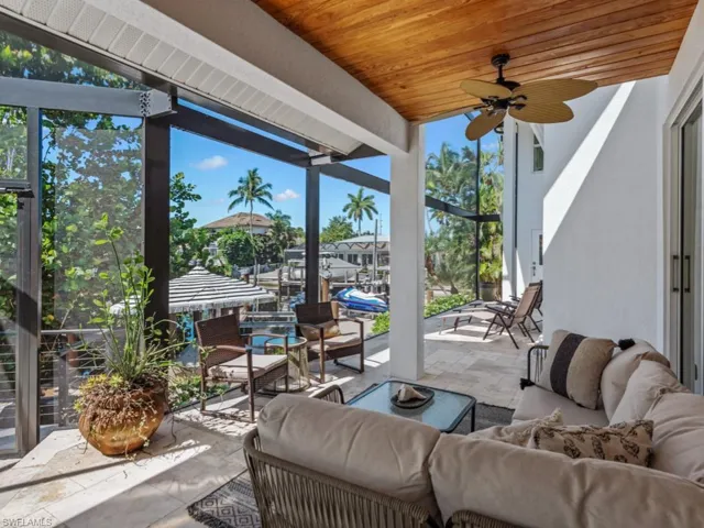 View of patio with an outdoor hangout area and ceiling fan