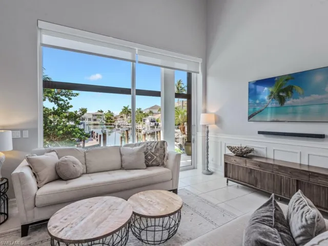 Living room featuring wainscoting and light tile patterned floors
