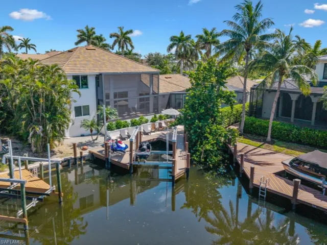 Dock area featuring boat lift and a water view