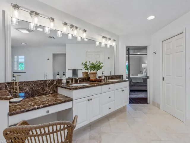 Ensuite bathroom featuring double vanity and recessed lighting