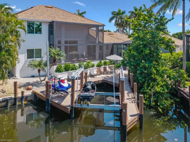 Dock area with boat lift and a water view