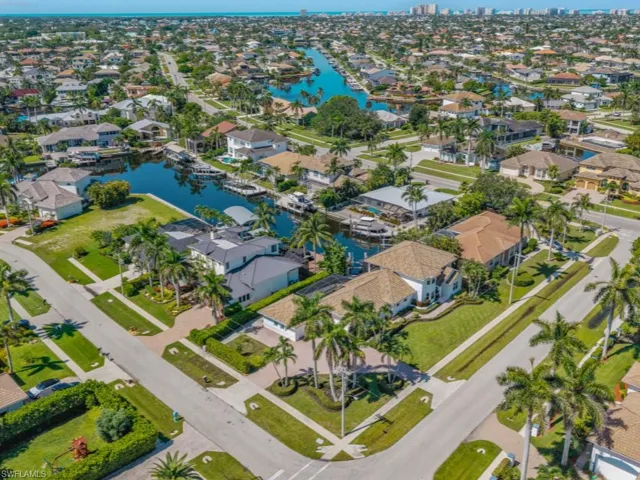 Aerial view of property's location with a nearby body of water and nearby suburban area