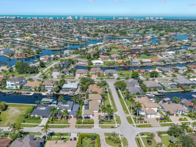 Aerial view of property and surrounding area with nearby suburban area