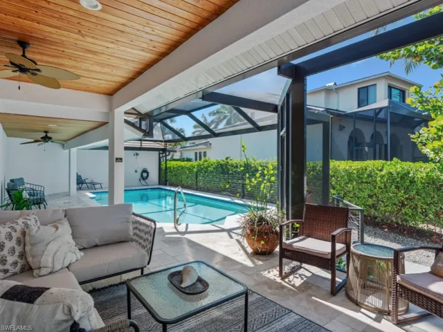 View of swimming pool with an outdoor living space, a ceiling fan, a patio area, and a lanai