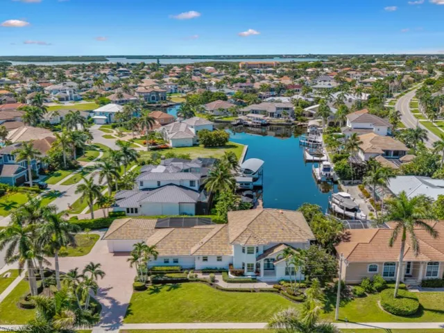 Aerial view of residential area featuring a large body of water