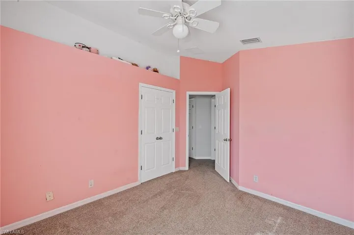 Unfurnished bedroom featuring carpet, a ceiling fan, and a closet