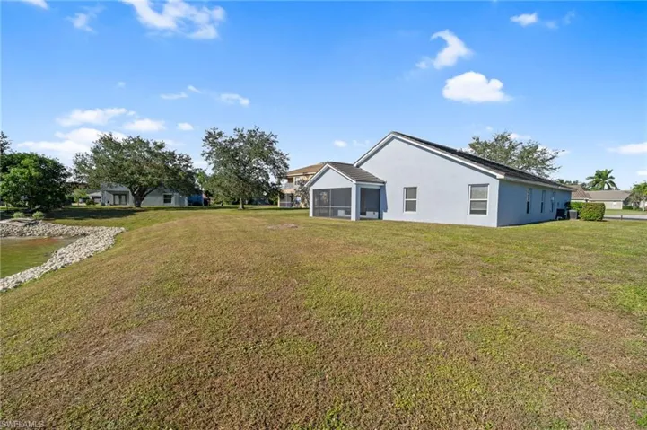 View of green lawn with a sunroom