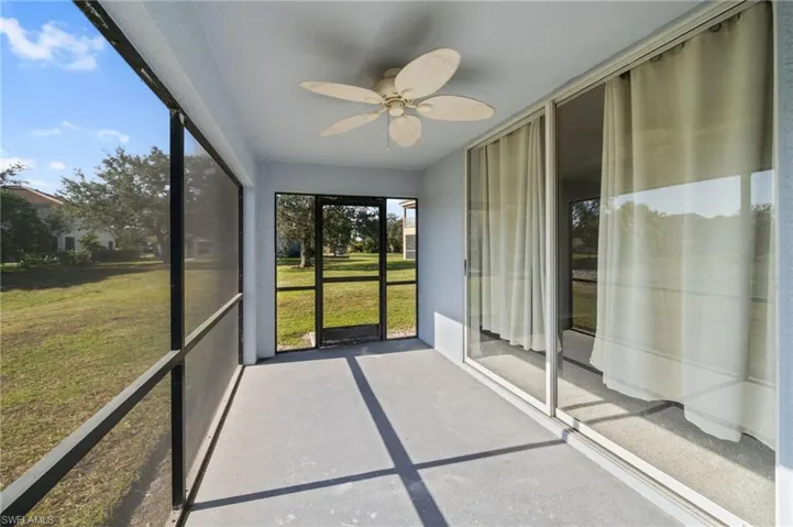Unfurnished sunroom featuring a ceiling fan