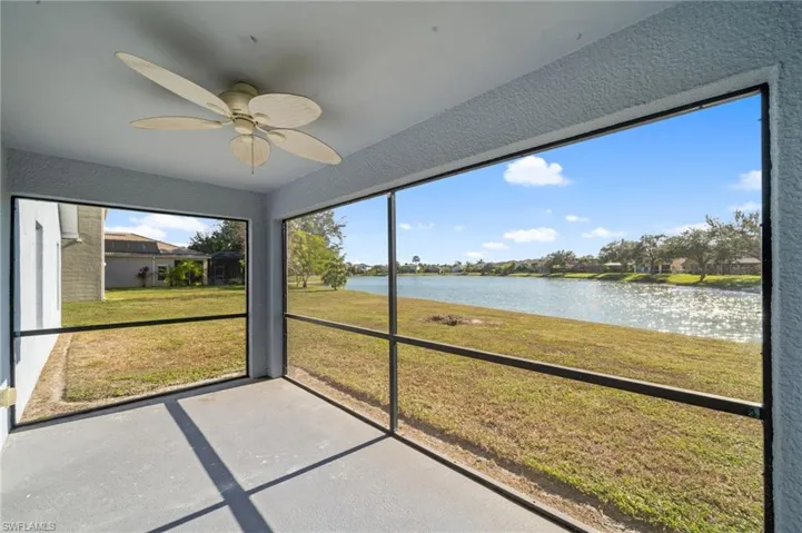Unfurnished sunroom with a water view and a ceiling fan