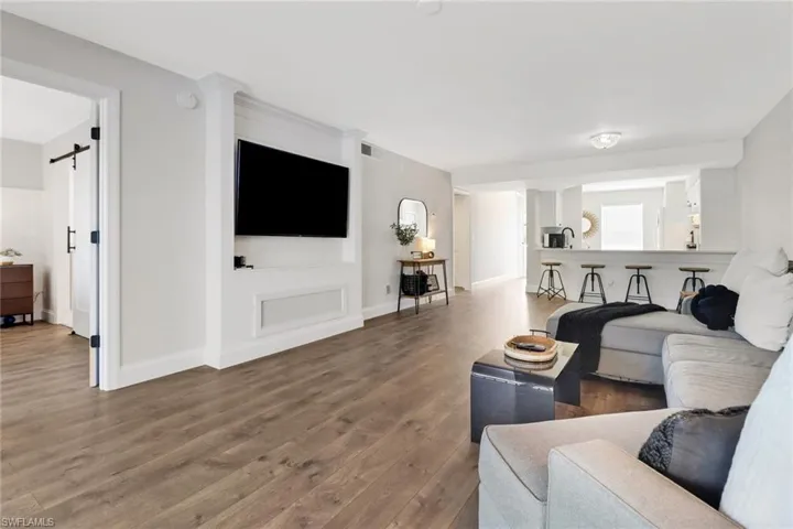 Living room with hardwood / wood-style floors and a barn door