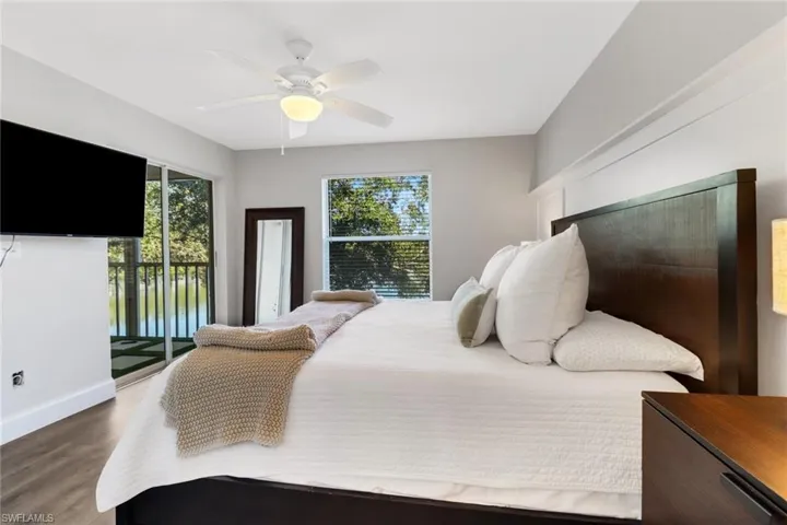 Bedroom featuring access to outside, ceiling fan, and hardwood / wood-style flooring