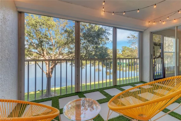Sunroom / solarium featuring a water view