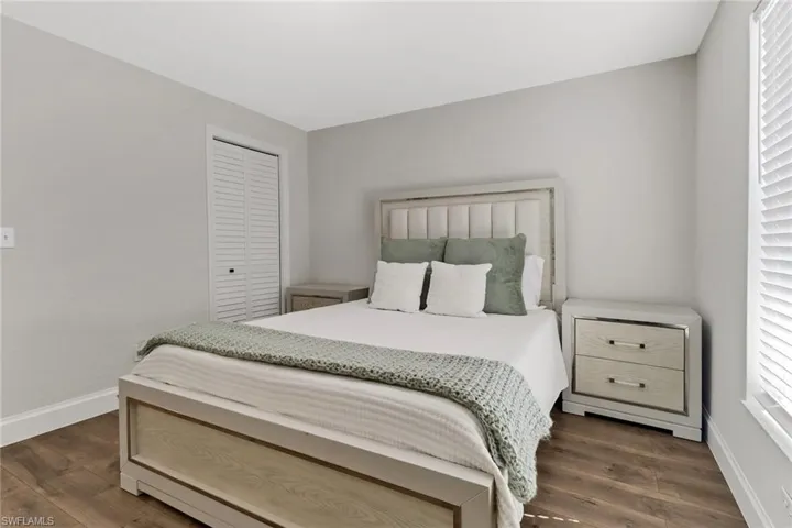 Bedroom featuring dark hardwood / wood-style flooring and a closet